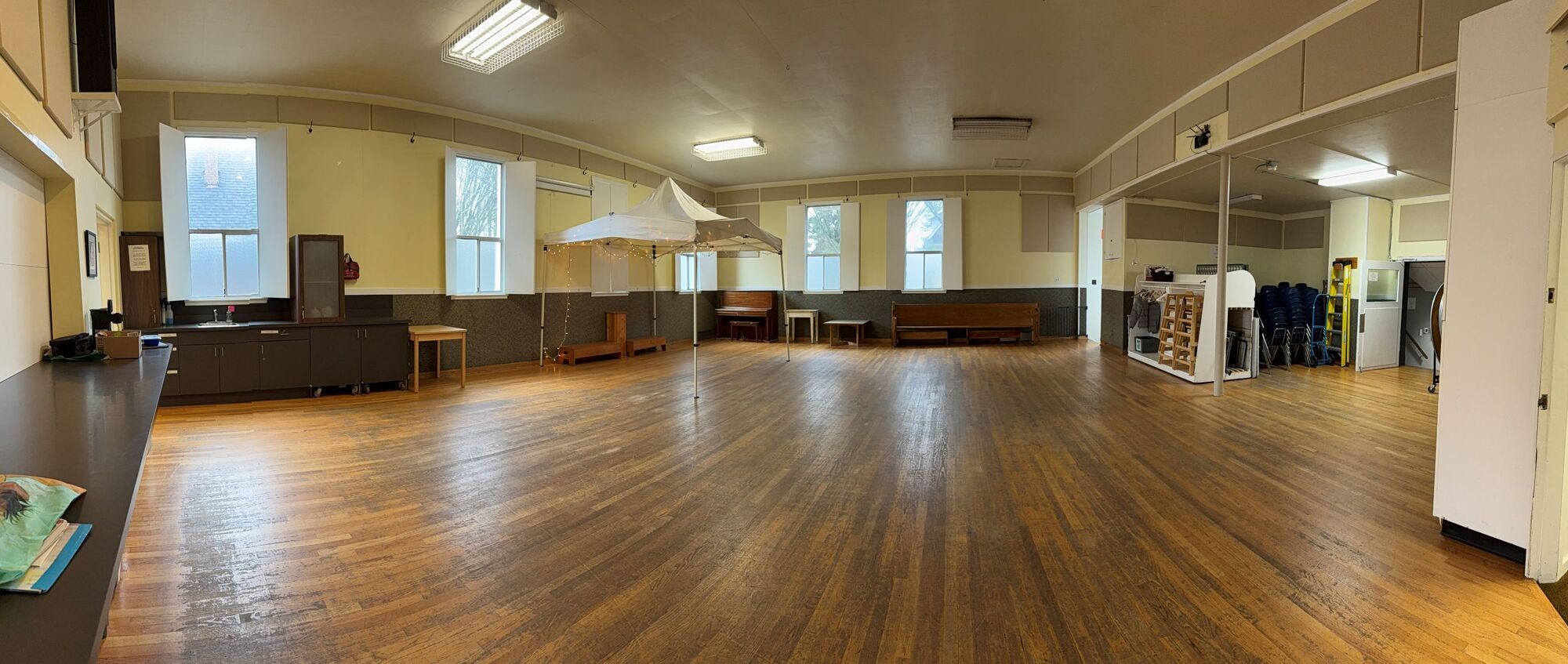 photo of our lower hall with hardwood floors and lots of windows