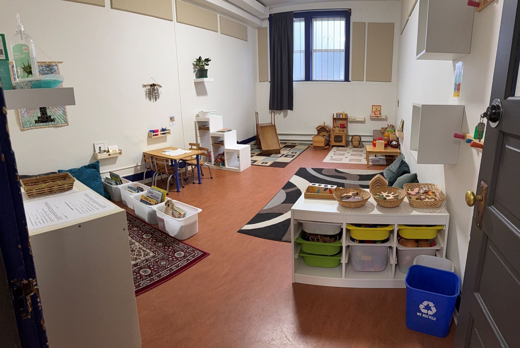 photo of a toddler playroom with toys and a slide