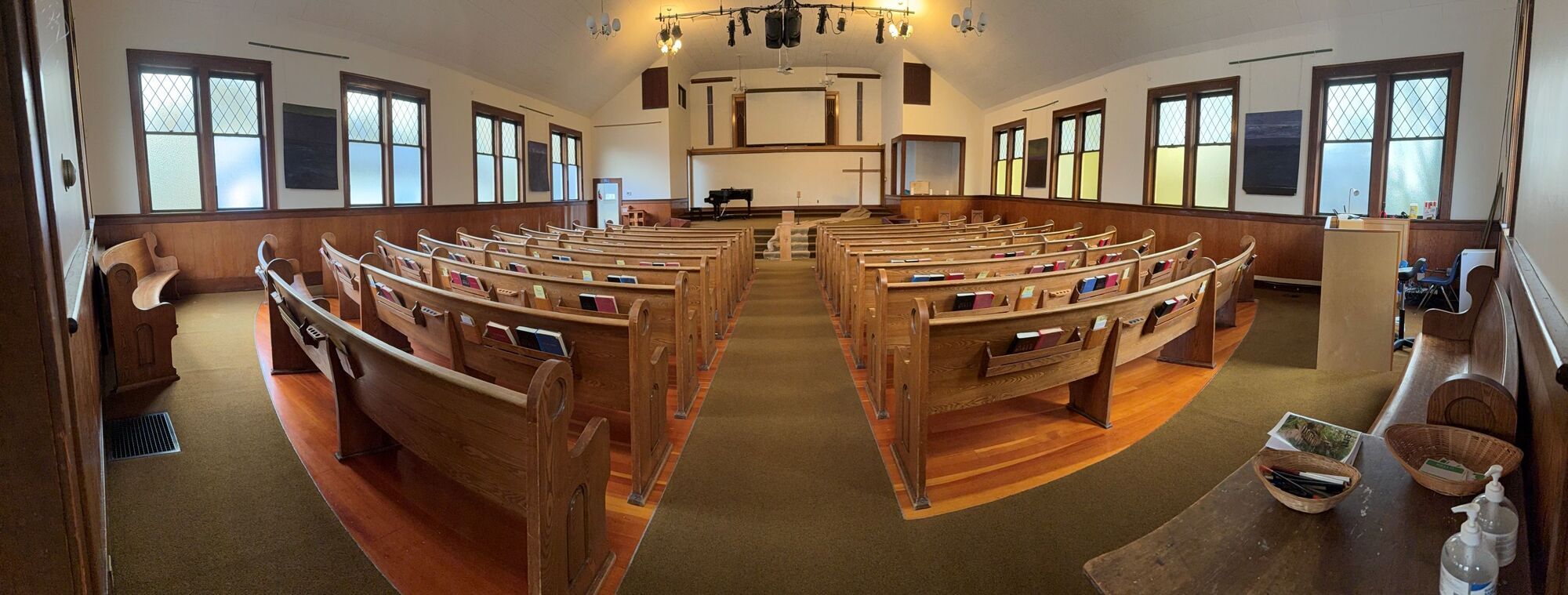 photo of a church space with pews and a stage