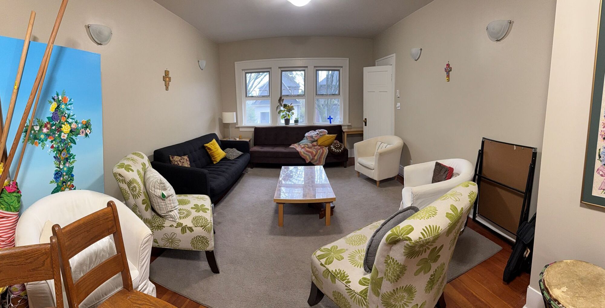 photo of a smaller room with couches and soft chairs