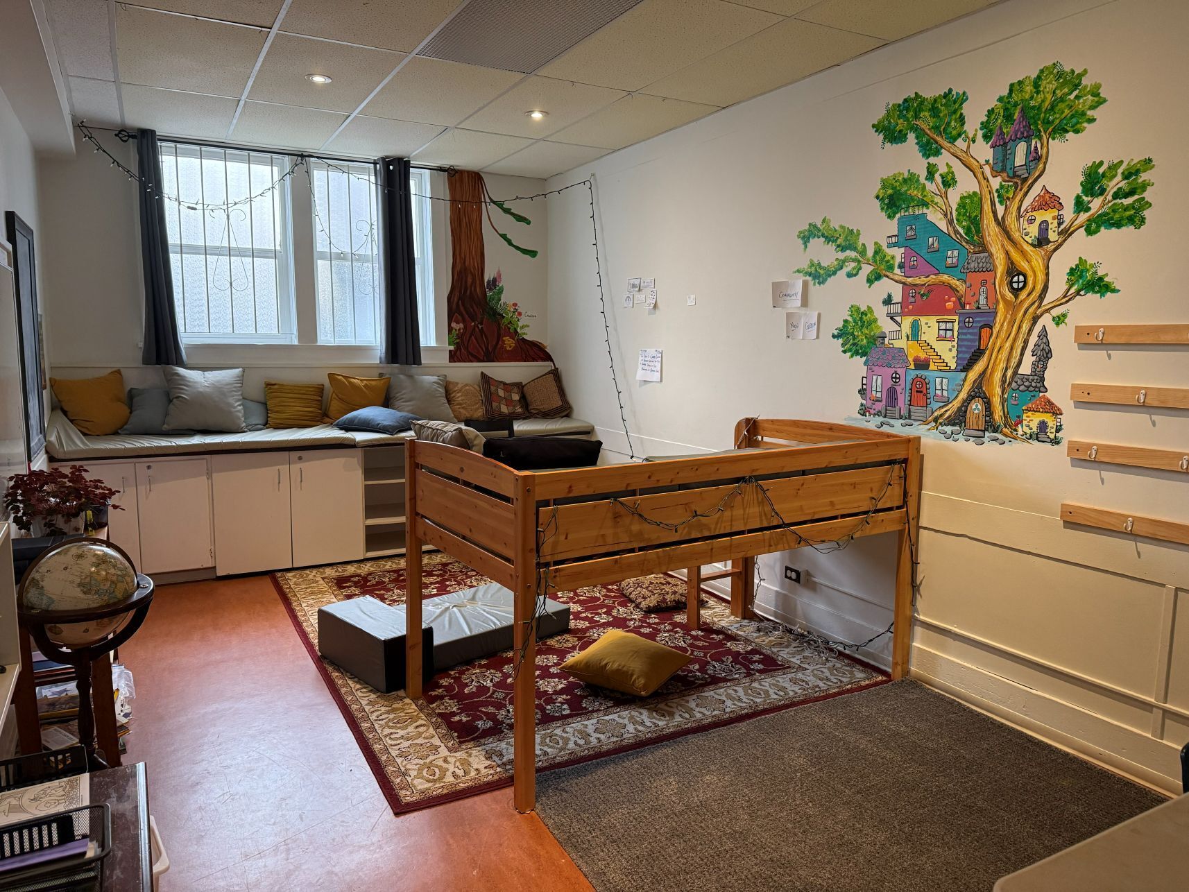 photo of a cozy room with pillows and a big rug
