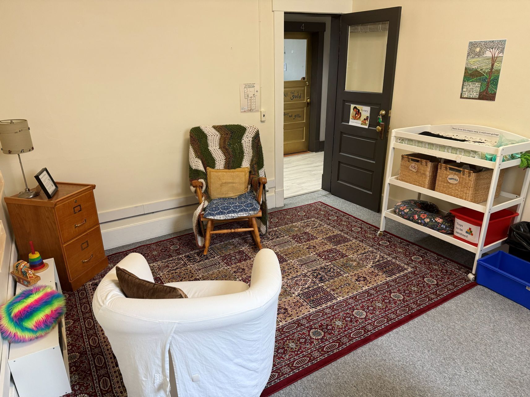 room with change table and nursing chairs